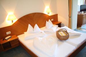 a hotel room with a bed with a basket on it at Seehotel Ressmann in Drobollach am Faaker See