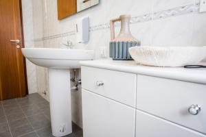 a white bathroom with a sink and a counter at Gabrielli Rooms & Apartments - MARONCELLI in Verona