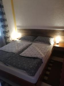 un letto con due cuscini sopra in una stanza di Apartments Plavčić a Plomin (Fianona)