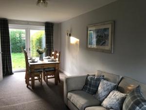 a living room with a couch and a table at 1 Silkin Serviced Accommodation in Newton Aycliffe