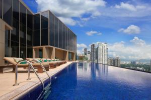 a swimming pool on the roof of a building at Pavilion Hotel Kuala Lumpur Managed by Banyan Tree in Kuala Lumpur