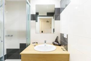 a bathroom with a sink and a shower at Hotel Concheiros in Santiago de Compostela