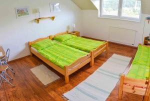 A bed or beds in a room at Penzión Gardoš