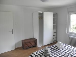 a bedroom with a bed and a dresser and a window at Island View Apartment in Bled