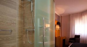 a bathroom with a shower and a walk in shower at Hotel Palacio de Cristal in Burela de Cabo
