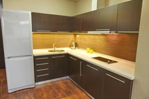 a kitchen with a white refrigerator and a sink at Velestovo House in Ohrid