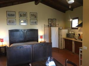 a bedroom with a large bed and a kitchen at Borgo Santa Lucia Monolocale in Castiglion Fiorentino