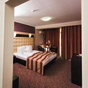 Säng eller sängar i ett rum på Hotel Ozana