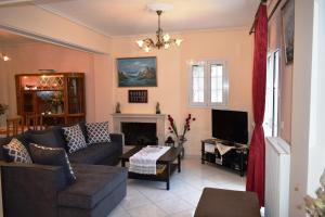 a living room with a couch and a fireplace at Casa de Calma in Argostoli
