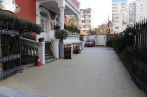an empty sidewalk in front of a house at Hotel Boutique Restaurant Gloria in Tirana