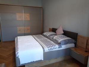 a bedroom with a bed with a large headboard at Praha white gardens in Prague