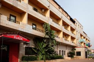 a building with a pizza sign in front of it at HOTEL PLAZA in Bamako