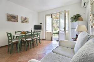 a living room with a table and chairs and a couch at Soleado beach house in Pietrasanta