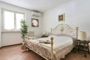 a bedroom with a bed and a table and chairs at Soleado beach house in Pietrasanta +20 photos