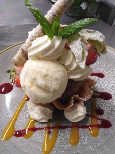 a dessert with ice cream and sauce on a plate at Wilde Ballybunion in Ballybunion