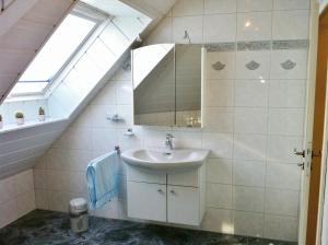 a bathroom with a sink and a mirror at Ferienwohnung Blau in Schweigen-Rechtenbach
