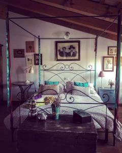 a bedroom with a bed with a metal canopy at Locanda San Tomaso in Treviso