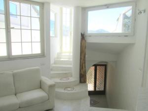 a living room with a couch and a fireplace at Sardinia Yellow House in Solanas