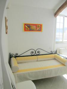 a room with a bench in a room at Sardinia Yellow House in Solanas