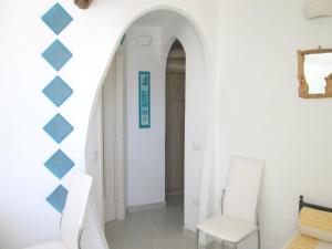 a hallway in a house with a blue and white wall at Sardinia Yellow House in Solanas