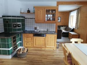 a kitchen with green appliances and a living room at Ferienhütte Antonia in Kliening
