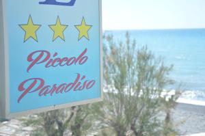 a sign for a pizza parlor with a view of the ocean at Hotel Piccolo Paradiso in Bordighera