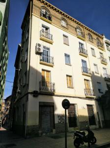 a motorcycle parked in front of a building at Apartamento centro san blas 36, próximo al Pilar in Zaragoza