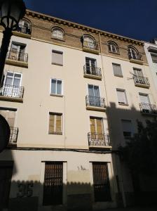 a large white building with windows and a street light at Apartamento centro san blas 36, próximo al Pilar in Zaragoza +24 photos