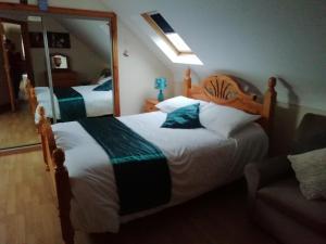 a bedroom with two beds and a large mirror at Joe and Aggies in Kilclooney
