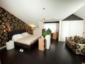 a bedroom with a bed and a couch at Hotel Bruman in Caserta