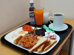 a plate of breakfast food on a table with a drink at Vicky's Garden in Kalamaki