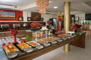 a buffet line with many different types of food at Aruanã Pousada in Jacumã