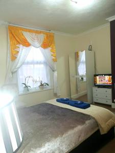 a bedroom with a large bed and a window at Gabriel Guesthouse in Rhyl