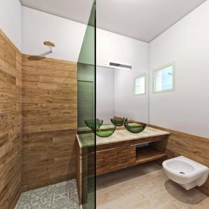 a bathroom with two sinks and a toilet at Hotel Botanic Golf SaCuba in Olbia