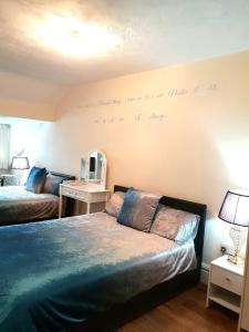 a bedroom with a bed and a mirror on the wall at Gabriel Guesthouse in Rhyl