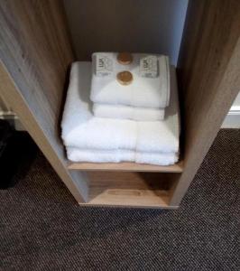 a white towel on top of a white towel rack at The Waverley Inn in Dingwall