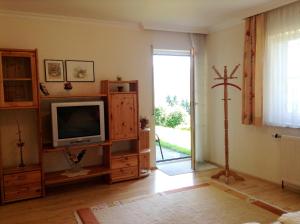 un soggiorno con TV su un centro di intrattenimento in legno di Haus Margit a Schlierbach