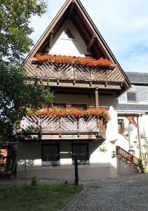 um edifício com uma varanda com flores em Ferienwohnung Neubert em Wolkenstein