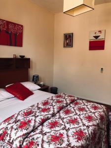 a bedroom with a bed with a red and white blanket at Exotic Copa Cabana Beachftont in Flic-en-Flac