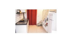 a kitchen with a sink and a refrigerator at Casa vacanza Civita Catania Centro in Catania