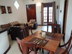 a dining room with a wooden table and chairs at Ice Berg in Mount Lavinia