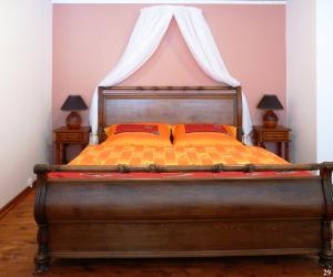 a bedroom with a large bed with a canopy at Resort Maják in Horní Soběšovice