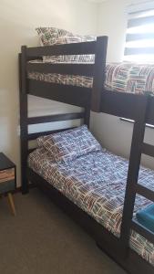 a couple of bunk beds in a room at Los robles II Pucon Casa Preciosa, FULL EQUIPADA in Pucón