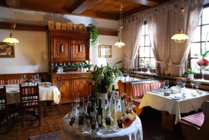 a restaurant with two tables with wine bottles on it at Hotel ZUM TURM in Kaub