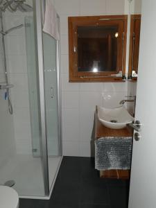 a bathroom with a sink and a shower at Chalet Bergmann in Bürchen