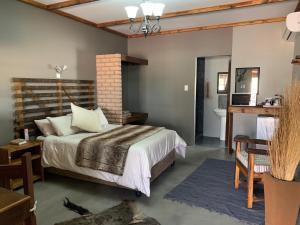a bedroom with a bed and a bathroom at Country Lodge in Upington +68 photos