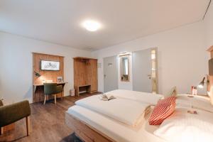 a hotel room with two beds and a desk at Löwen Hotel & Restaurant in Marktbreit