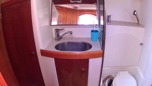 a bathroom with a sink and a toilet at Scugnizza Smeralda in Cannigione