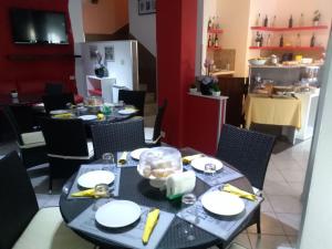 una sala da pranzo con tavolo, piatti e cibo di Perla Del Mare Affittacamere a Campofelice di Roccella