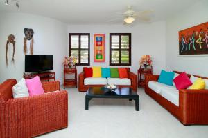 a living room with two couches and a tv at Cabarete Palm Beach Condos in Cabarete